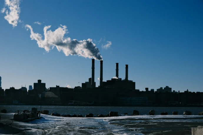 a factory with smoke coming out of it's stacks
